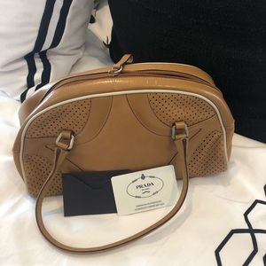 Tan Prada leather bowler bag.